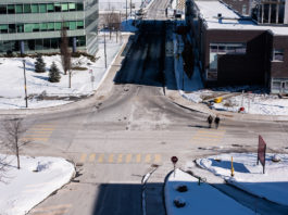 Pedestrians walk across Campus Ave during a cold winter afternoon