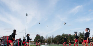Ravens drop home opener in low-scoring Bytown Battle Women's soccer players playing keep up.