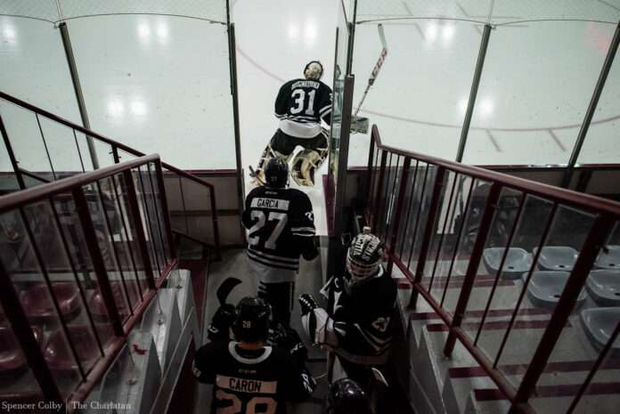 Hockey players enter rink. [Photo by Spencer Colby]