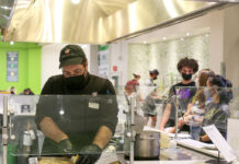 Opinion: Students should be able to take food out of the residence cafeteria A Caf worker wearing a black mask and gloves, preparing food