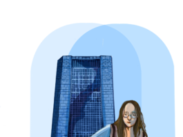 A mother sitting and studying while holding the t-shirt of her baby who is crawling away. Dunton tower stands in the back.