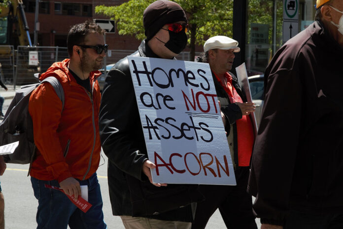 A man holding a sign at a demonstration.