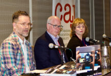 Canadian media workers experience higher rates of mental illness, report says Three people at a conference with microphones in front of them.