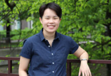 The future of journalism is in Tobin Ng’s hands Photo of person leaning back with trees behind them.
