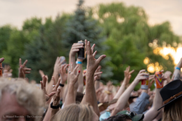 Fans raise their hands in the crowd at Bluesfest.