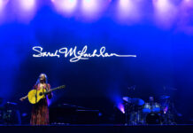 Review of Bluesfest Day One: Festival kicks off with two Canadian headliners Sarah McLachlan performs on the stage at Bluesfest. Her name is projected on the screen behind her.