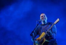 Review of Bluesfest Day Two: Hot tunes under the summer sun Jack Johnson performs at Bluesfest. He is smiling at the crowd, holding an acoustic guitar.