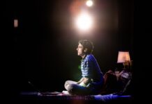 Review: Broadway Across Canada’s ‘Dear Evan Hansen’ fills stage with passion and emotion Anthony Norman as Evan Hansen sits on his bed looking out into the audience.