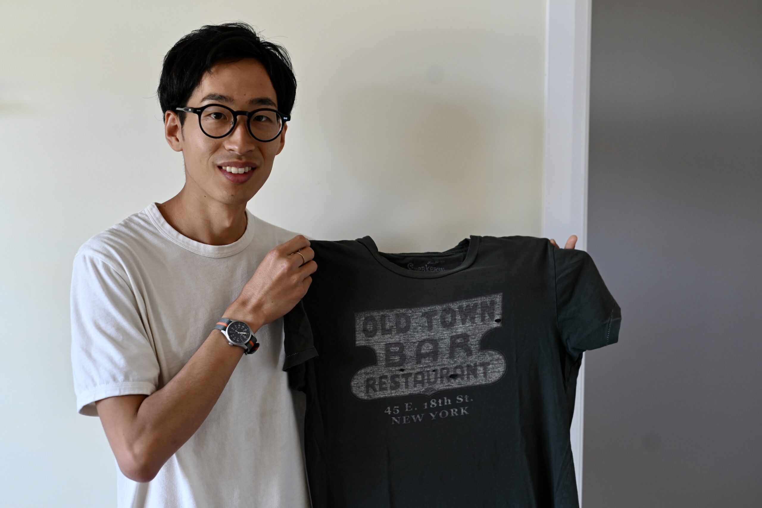 Shuya Yanagisawa holds up his favourite t-shirt