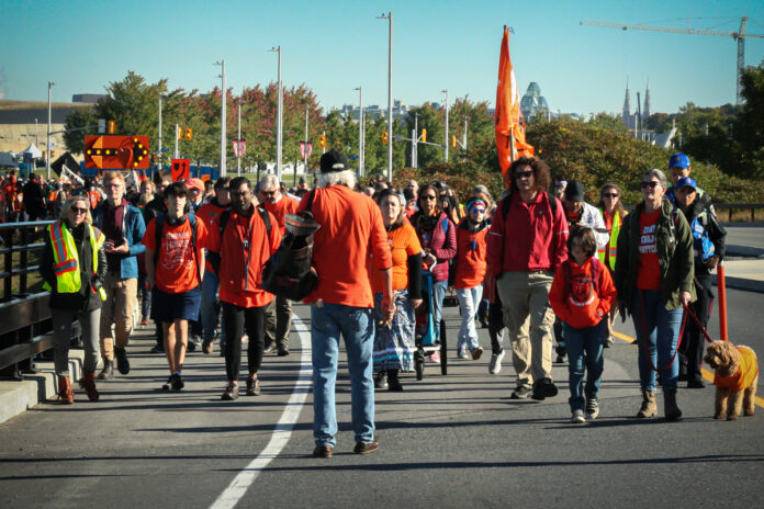 Protestors march along Sir John A. Macdonald Parkway
