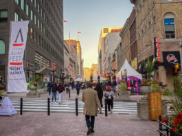 Ottawa Asian Fest banners line Sparks Street as the sun sets between the buildings.