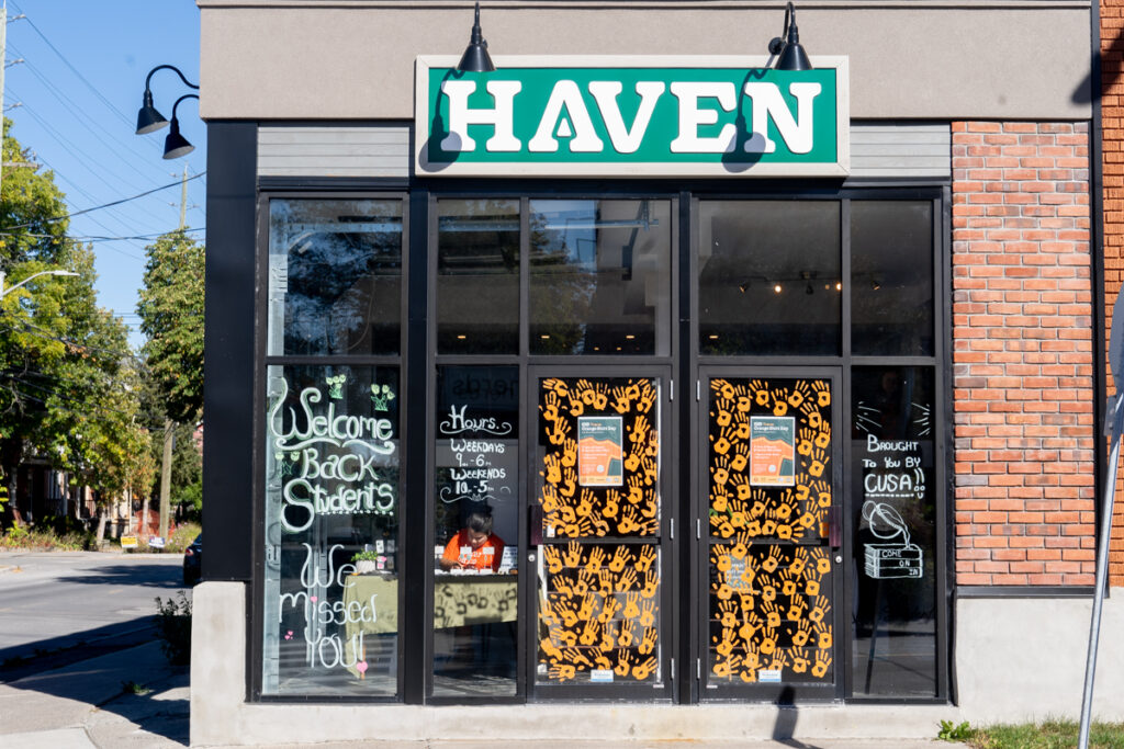 A store with orange hand prints on its doors.