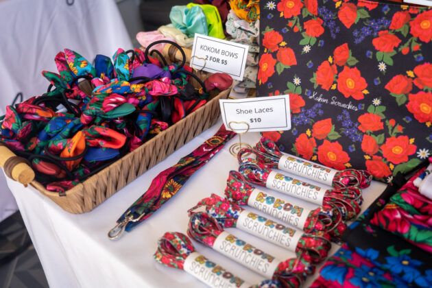 Bows and shoe laces for sale on a table.