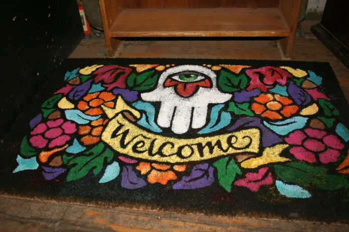 A colourful doormat is pictured on a doorstep, as part of the Welcome Back Project.