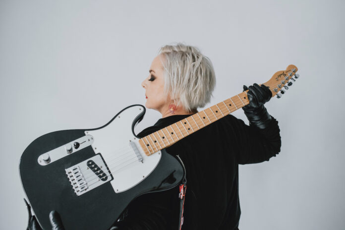 Dawn Sev poses with her guitar in 2022. [Photo provided by Dawn Sev]
