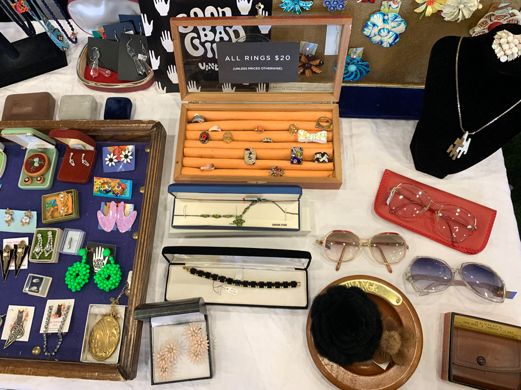 Items such as rings, earrings and sunglasses on display on a table at Ottawa Antique and Vintage Market.