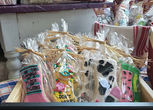 Sock-shaped sugar cookies sit in a basket.