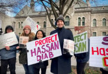 Activists and Carleton students rally in support of Hassan Diab People standing smiling holding signs in support of Hassan Diab