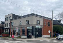 CUSA axes Haven’s beloved book service Grey coffee shop at the corner of an intersection with cloudy skies.