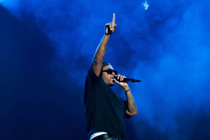 Hip-hop legend Nas raises his hand in the air during his performance at Bluesfest on July 14, 2024. [Photo by Darren Tran/The Charlatan]