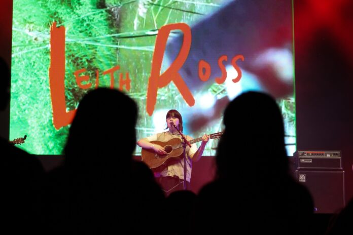 Queer fans watch indie sensation Leith Ross strum the guitar and sing on July 4, 2024. [Photo by Natasha Baldin/The Charlatan]