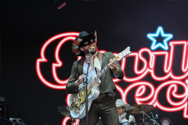 Orville Peck in his signature black eye mask and western attire performing on July 4, 2024. [Photo by Natasha Baldin/The Charlatan]