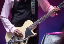 Review of CityFolk Day Five: Eclectic sounds and stories wrap last day Close up shot of a man strumming a yellow guitar on stage. Pic is just of his hands and the guitar.