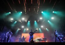 Review of CityFolk Day Four: Folk favourites with a twist Green and purple strobe lights flash as a 2 guitarist, a drummer, and keyboardist are on stage.