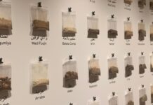 CUAG’s ‘A Dream of Return’ showcases creative resistance through contemporary art Bags of dirt with place names under it attached to the wall.