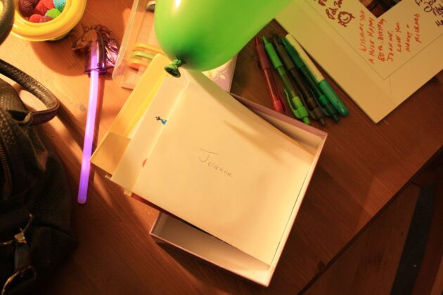 Stacks of birthday cards piled up alongside a balloon