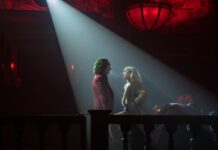 Review: ‘Joker: Folie à Deux’ is laughably bad With a white spotlight on them, Joker and Harley Quinn talk in a dark restaurant