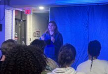 Sock ‘n’ Buskin’s monologue night gives performers a chance to act out dream roles Amid a blue background and a crowd watching, a girl in a blue bottom down shirt acts out a scene from The Edge of Seventeen.