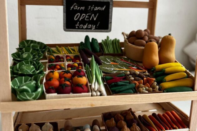 A miniature farm stand full of tiny clay vegetables.