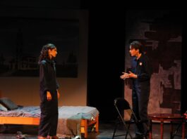 On stage, the two main characters in 1984, Julia and Winston, have a heated discussion.