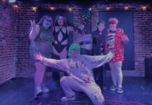 ‘Diverse, powerful and political’: Ottawa’s growing drag community pushes for diversity In a purple light, six people smile and hug each other for a photo. With five people standing and one in front with their arms out. The five in the back are all drag artists in drag makeup.