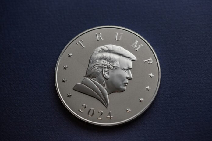 A 2024 President Donald J. Trump silver coin sits on a simple textured background.