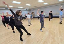 Broadway Workout brings the fun to workout classes A group of dancers, all women and men in their mid to late 30s, dance with their arms out stretch while sliding to the right.
