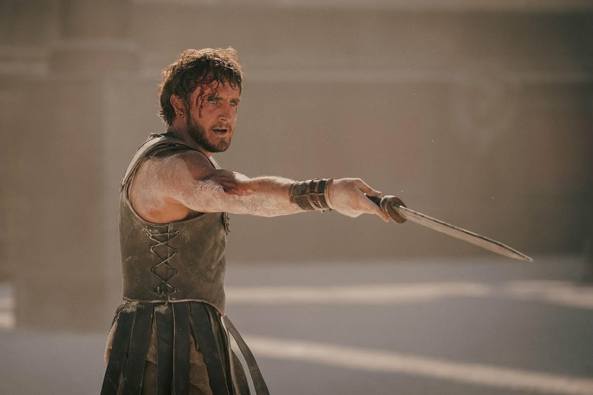 Paul Mescal portrays Lucius’s torment with sunken expressions and a solemn gaze in Gladiator II. The actor is holding out his sword and is wearing battle armour. 