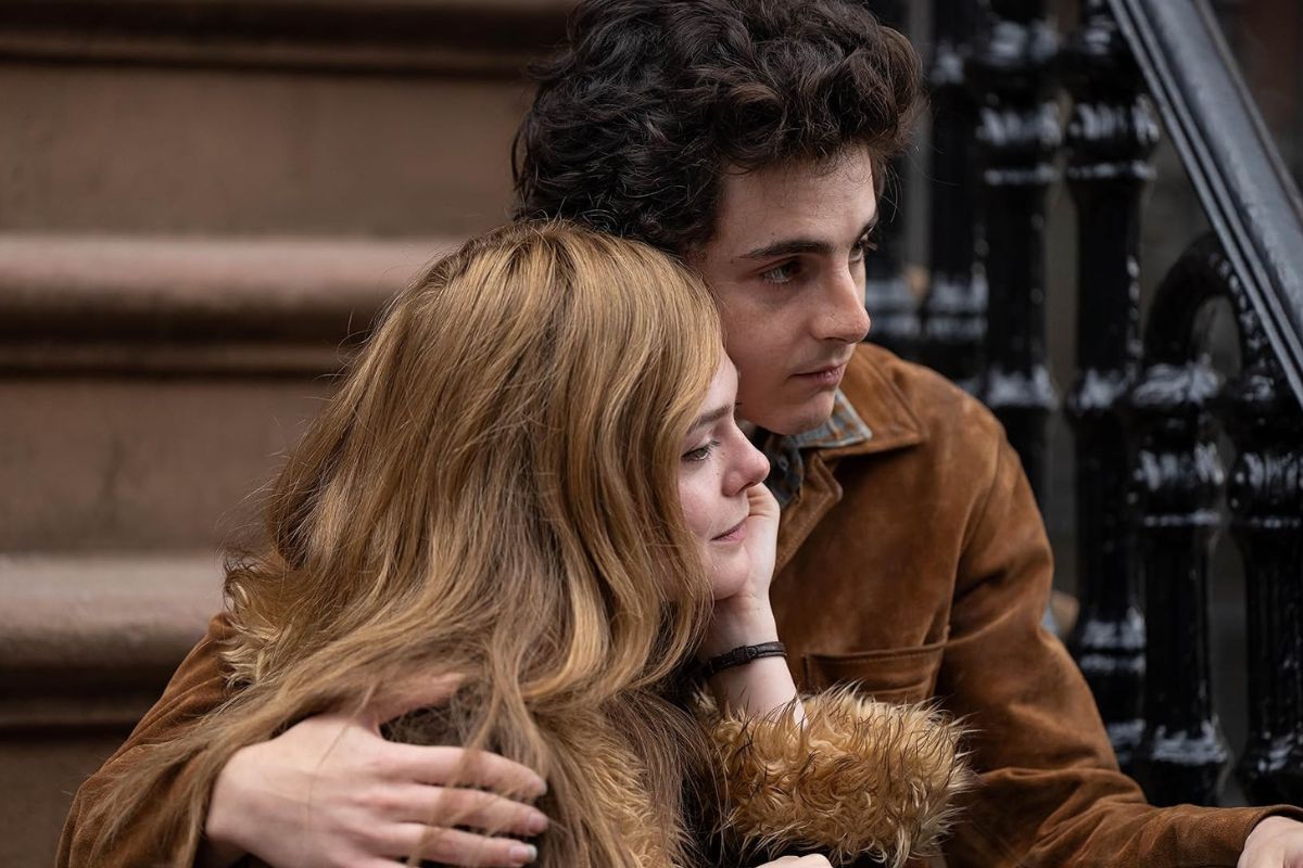 Timothée Chalamet gives a one hard hug to Elle Fanning outside on the steps of a New York apartment building. 