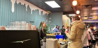 A barista at EP Café interacts with a customer at the cafe cash register during the launch event on Jan. 22, 2025.