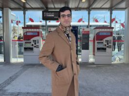 Documentary filmmaker Gio Petti stands in front of OC Transpo’s Line 2 Carleton University train stop on Jan. 9, 2025.