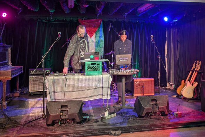 Caption: SUBR musical duo Nicholas LePage (left) and Lougien Dawoudiah (right) perform at Live! On Elgin in a charity concert supporting a community defence fund on Jan. 9, 2025. [Photo by Grace Huntley/The Charlatan]