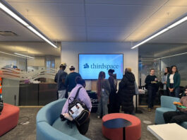 Students gathered around a sign reading Third Space