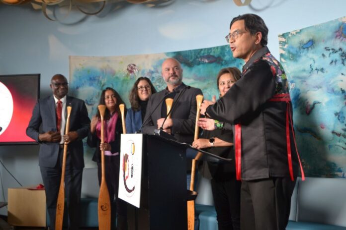 Carleton staff (Duncan McCue, Allan Thompson, Wisdom Tettey) and partners gather at Ojikwanong Indigenous Student Centre to celebrate the launch of a new Indigenous journalism certificate on Jan. 29, 202.