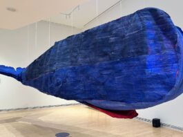 Artist Cynthia Girard-Renard’s paper whale ‘Tryphon’ suspended from the ceiling as part of the exhibit ‘The Air of the Now and Gone’ at the Carleton University Art Gallery on Jan. 26, 2025.