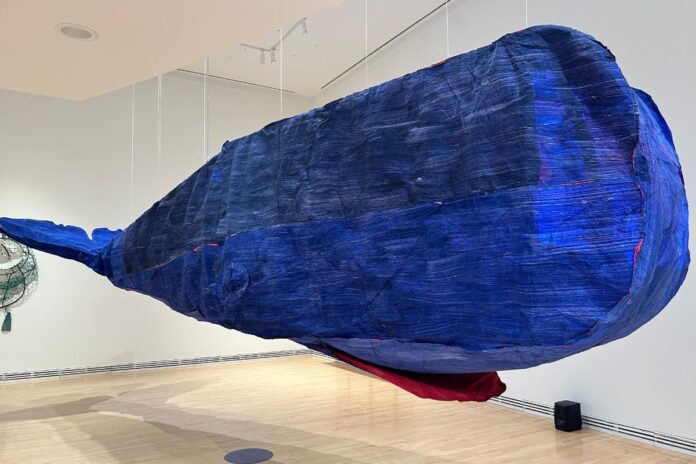 Artist Cynthia Girard-Renard’s paper whale ‘Tryphon’ suspended from the ceiling as part of the exhibit ‘The Air of the Now and Gone’ at the Carleton University Art Gallery on Jan. 26, 2025.