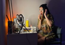 ‘Stronger together’: How Ottawa drag artists find identity and community A drag queen puts lip gloss on her lips in front of her vanity mirror.