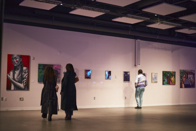 Down the hall from the demo stage, participants observe artwork and photography at the Crépu: Our DNA event on Feb. 2, 2025.