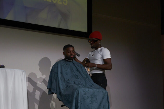 The owner of the ROVN, a mobile barbershop, gives a live barber demonstration and takes questions from the audience at the Crépu: Our DNA event on Feb. 2, 2025.