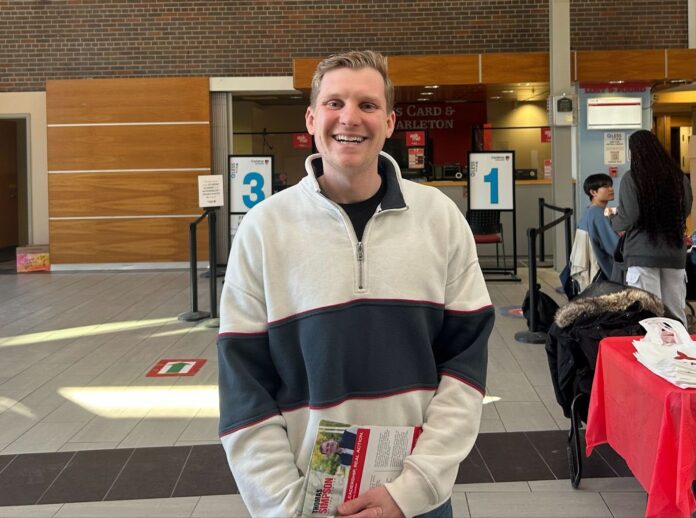 Man smiling in a quarter-zip sweater.